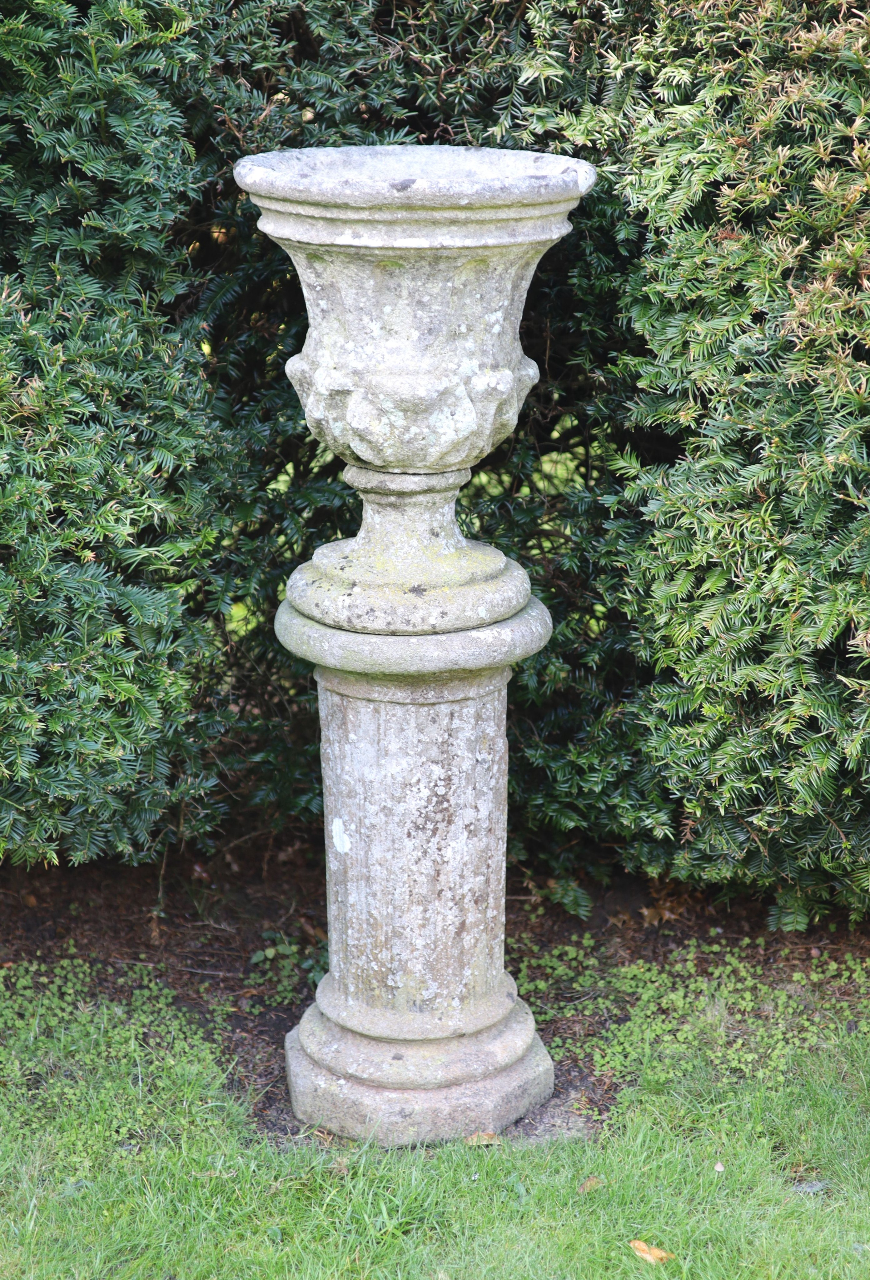 A reconstituted stone garden urn on fluted pedestal, height 112cm diameter 40cm